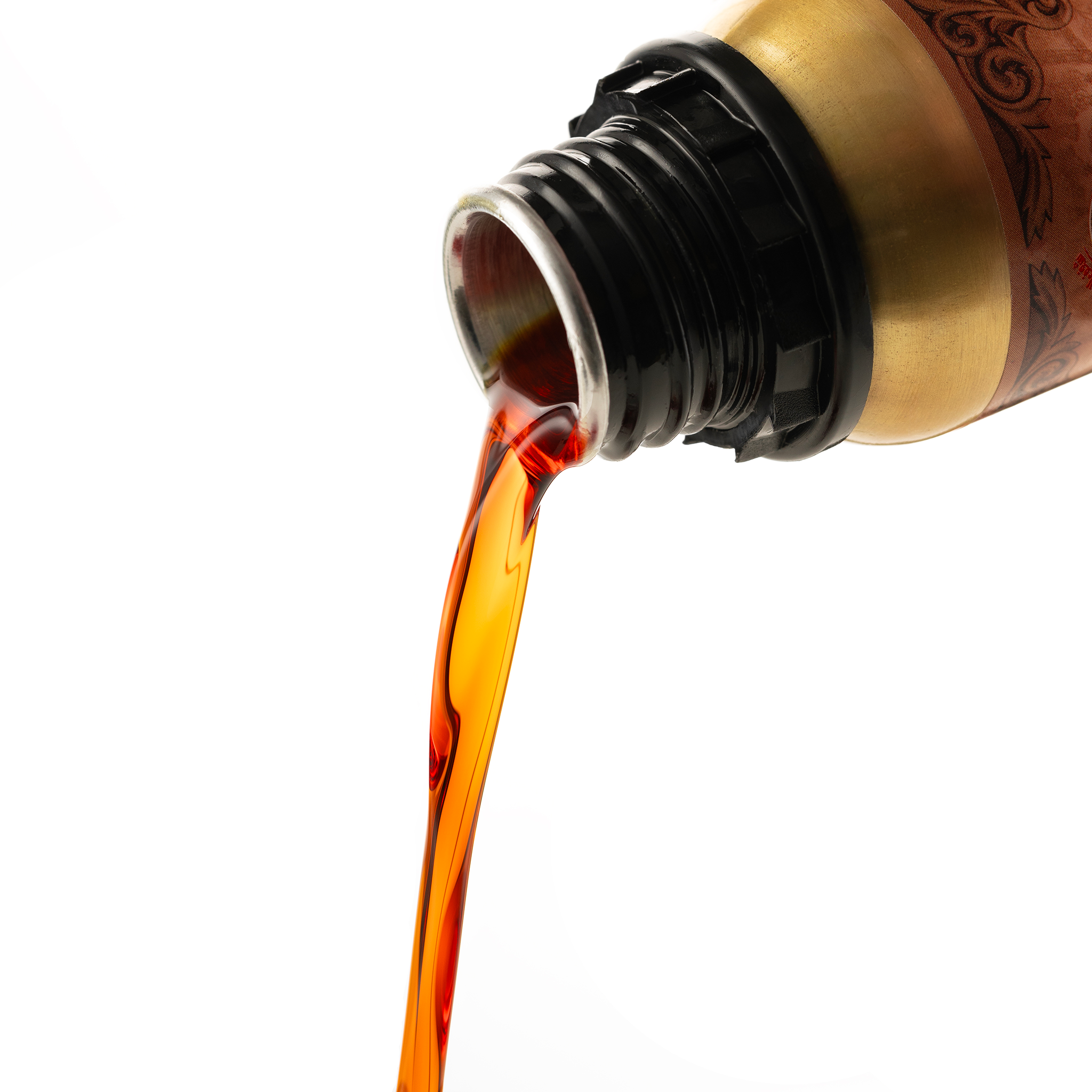 Mukhallat Bakhour Al-Oud 100 g pouring in an amber stream from the gold bottle, close-up