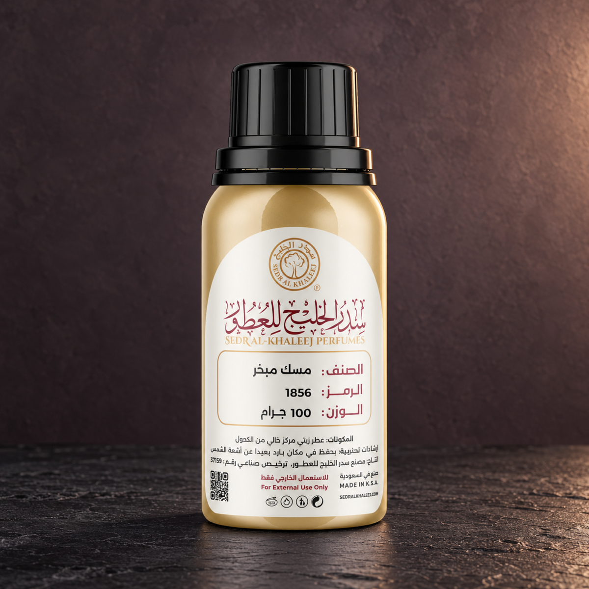 Sedr Al-Khaleej musk mubakhar perfume oil; one closed original bottle on matte black slate before a smoky mauve, dark charcoal backdrop.