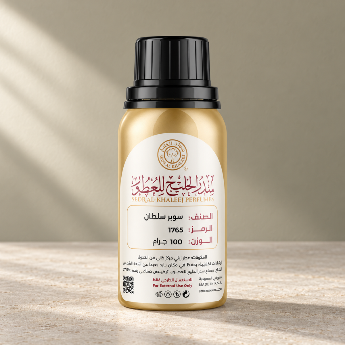 Sedr Al-Khaleej super sultan perfume oil; one closed original bottle on greige honed limestone before a muted amber sage, pale greige backdrop.