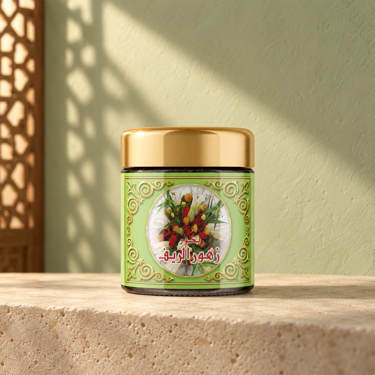 Zuhoor Al-Reef Bakhoor 40 g from Sedr Al-Khaleej; green incense jar with a gold lid on limestone against a pale sage wall in angled sunlight.
