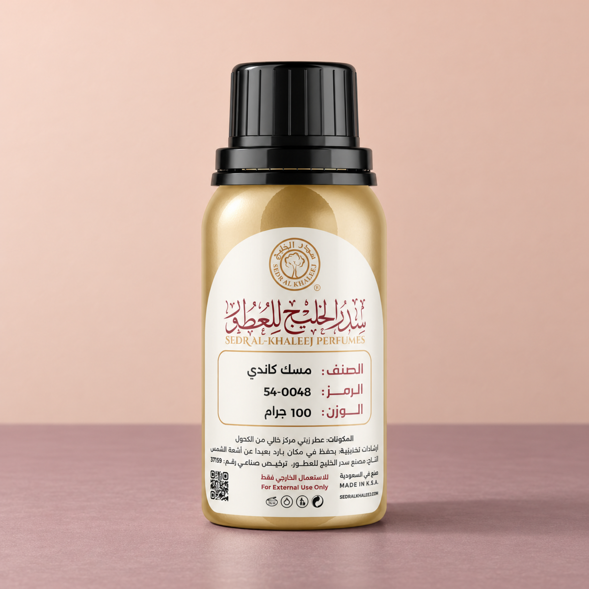 Sedr Al-Khaleej candy musk perfume oil; one closed original bottle on matte muted-mauve ceramic, against plain powder-peach wall.