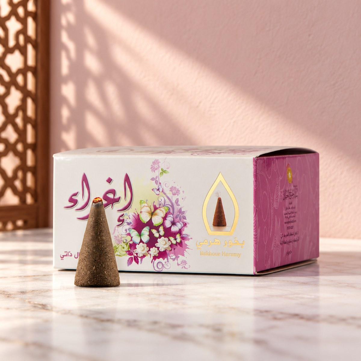 Eghra Pyramid Bakhoor 50 g from Sedr Al-Khaleej; white and pink incense box with butterfly printing and one cone on white marble against a pale pink wall.