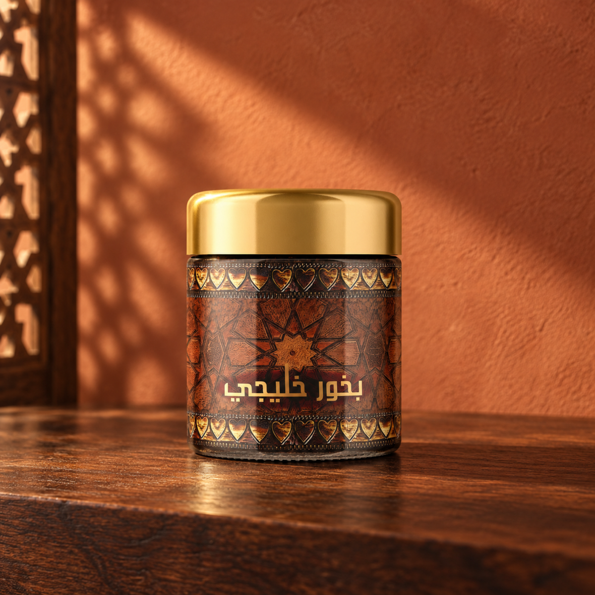 Khaleejy Bakhoor 40 g from Sedr Al-Khaleej; incense jar with a gold lid and ornate brown label on wood against a terracotta sunlit wall.