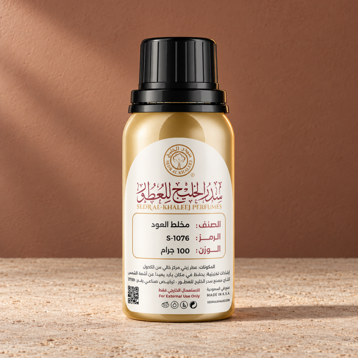 Sedr Al-Khaleej mukhalat al oud perfume oil; one closed original bottle on pale textured sandstone before a muted brick, grey ochre backdrop.