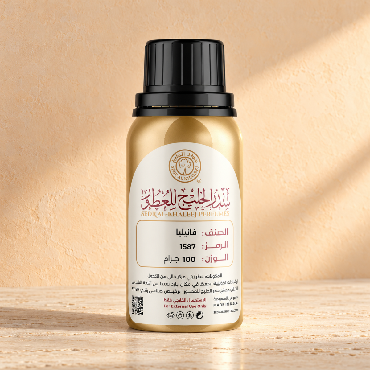 Sedr Al-Khaleej vanilla perfume oil; one closed original bottle on cream travertine with restrained fine horizontal veining, against pale apricot limewash wall.